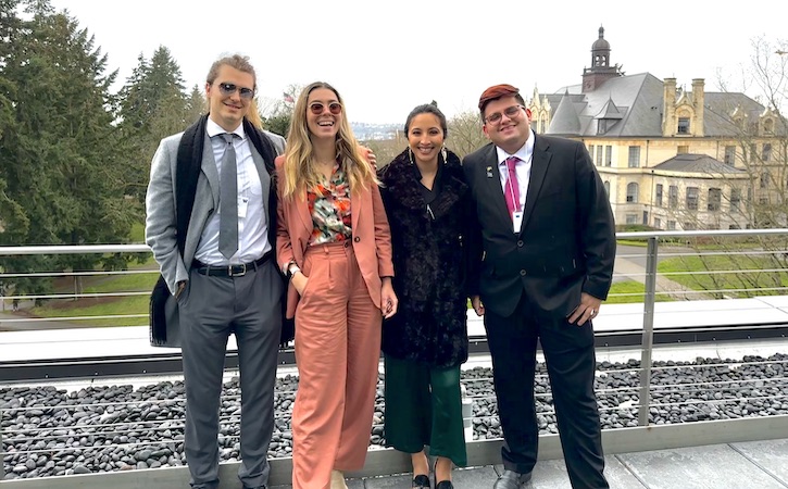 Four IR students at conference, outside, posing