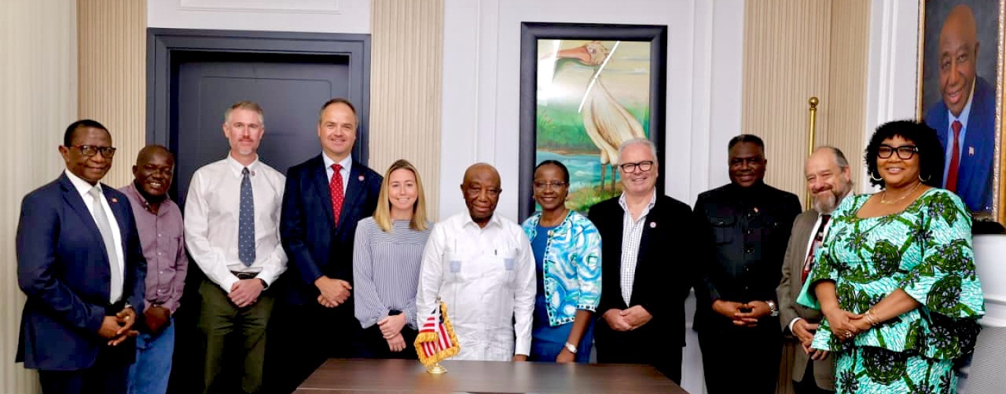 Andrew Clark with his team and represenetitives of the Liberian state